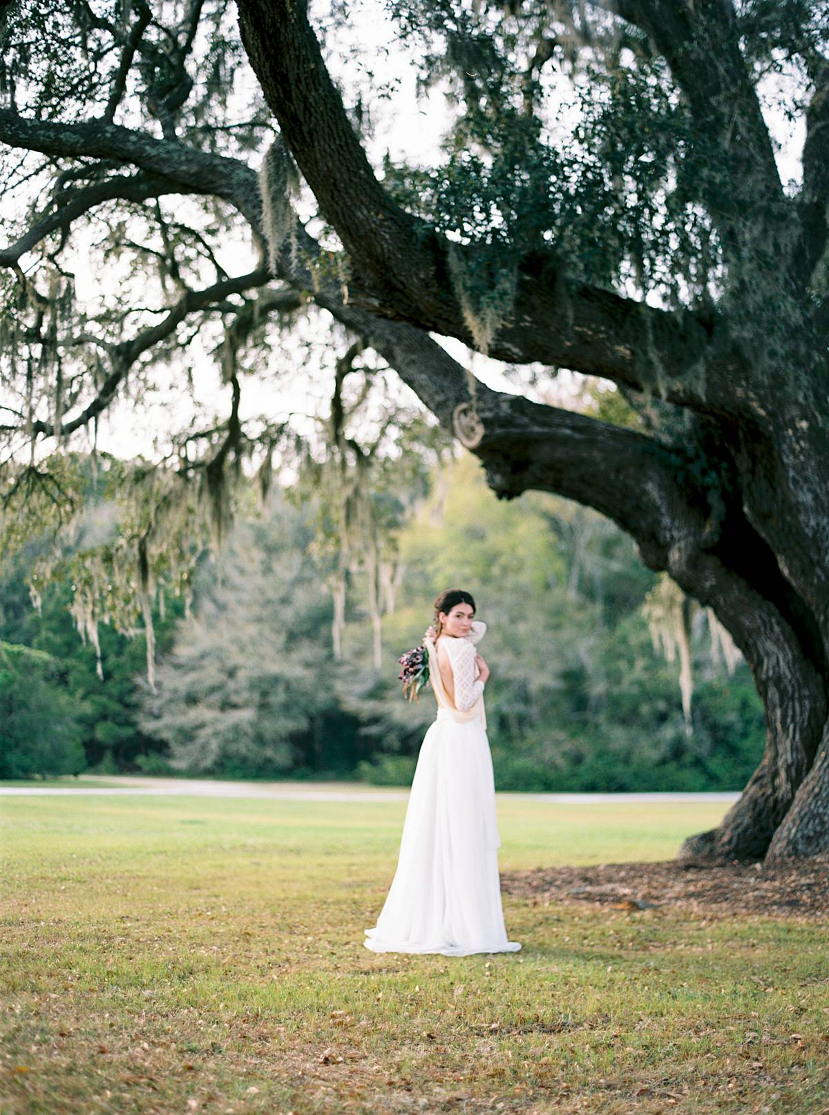 wingate plantation oak trees with charleston south carolina bride during wedding in bodysuit dress at sunset
